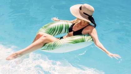 Woman floating in water. Summer Promo