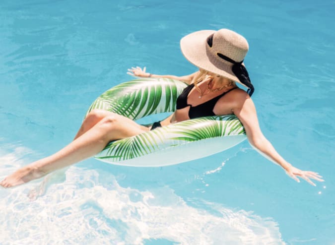 Woman floating in water. Summer Promo